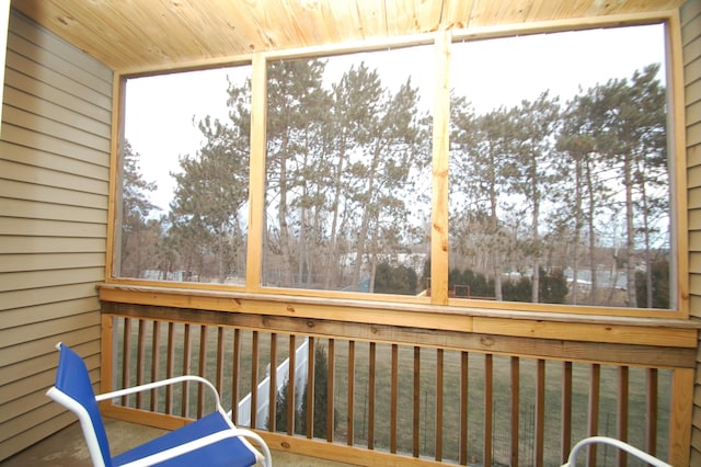 unfurnished sunroom with wood ceiling