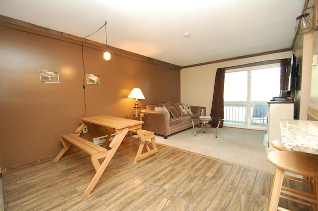 living room with crown molding and wood-type flooring