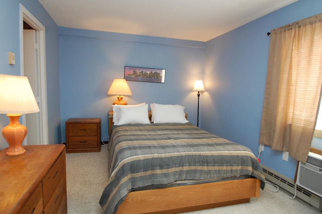 carpeted bedroom featuring a baseboard heating unit