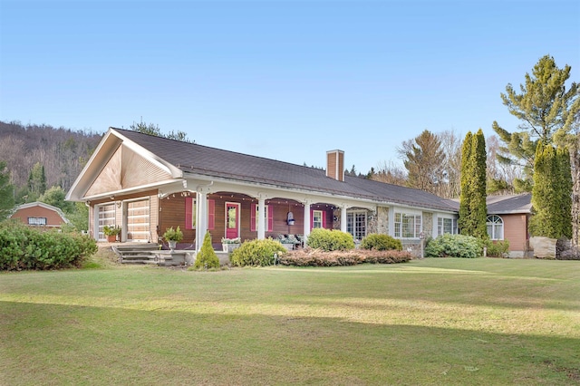 ranch-style home featuring covered porch and a front yard