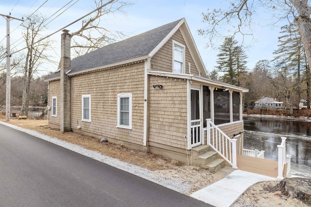 view of side of property with a sunroom