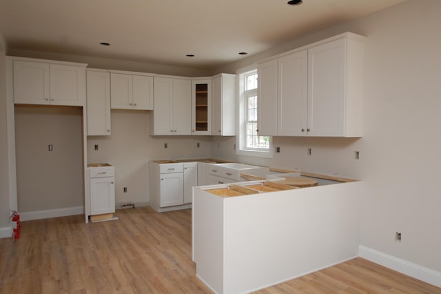 kitchen with white cabinets and light hardwood / wood-style floors