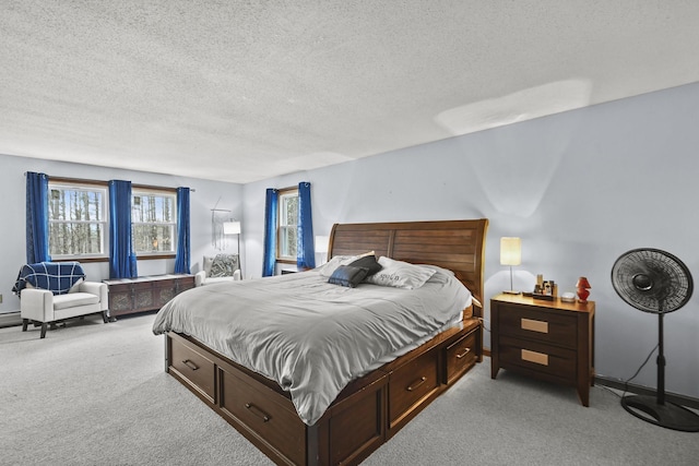 bedroom featuring light carpet and a textured ceiling