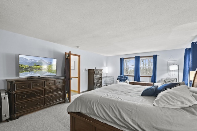 bedroom with a textured ceiling and light carpet