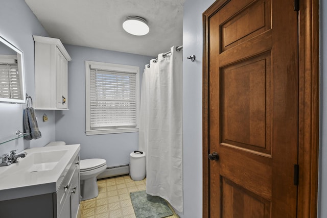 bathroom featuring vanity, toilet, and a baseboard radiator