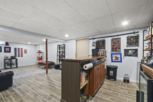 bar with a paneled ceiling and wood counters