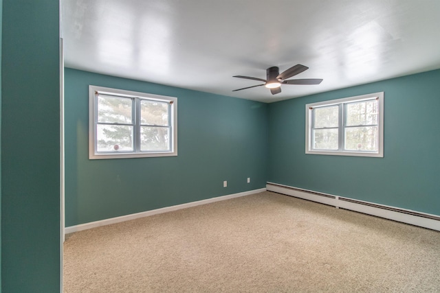 unfurnished room featuring carpet, plenty of natural light, and a baseboard radiator