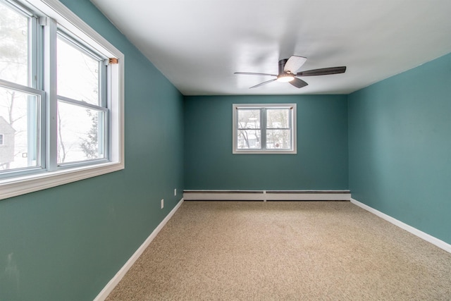 carpeted spare room with baseboard heating and ceiling fan