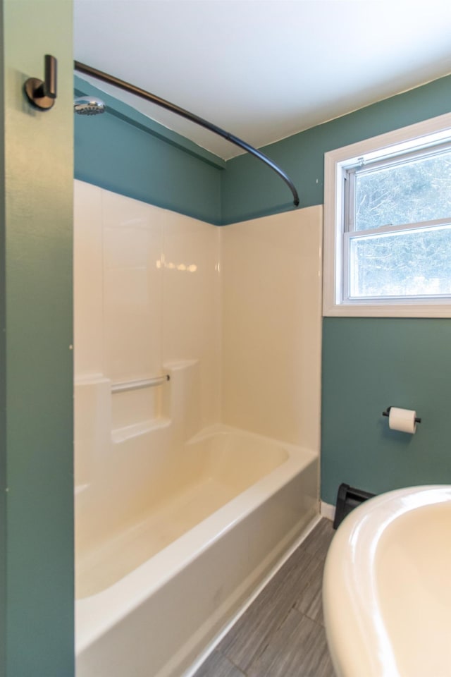 bathroom featuring sink, wood-type flooring, and tub / shower combination