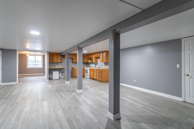 basement featuring light wood-type flooring and a baseboard radiator