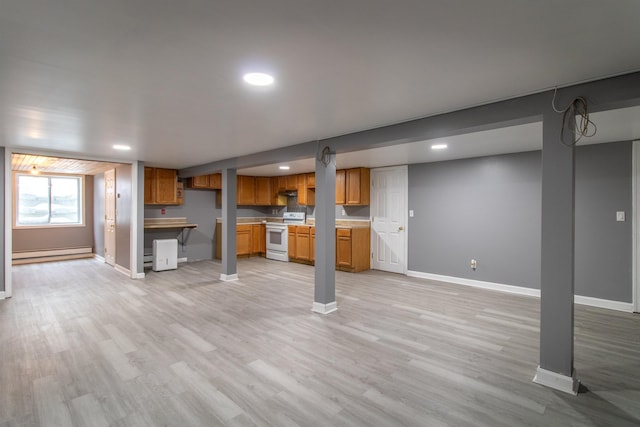 interior space with light wood-type flooring, a baseboard heating unit, and electric stove