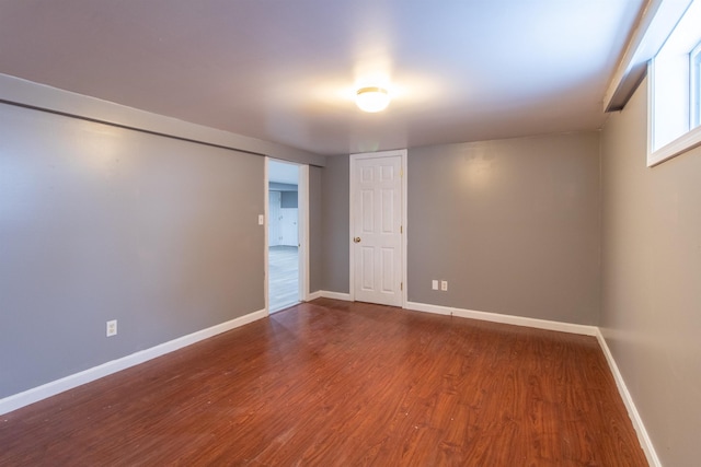 unfurnished room with dark hardwood / wood-style floors