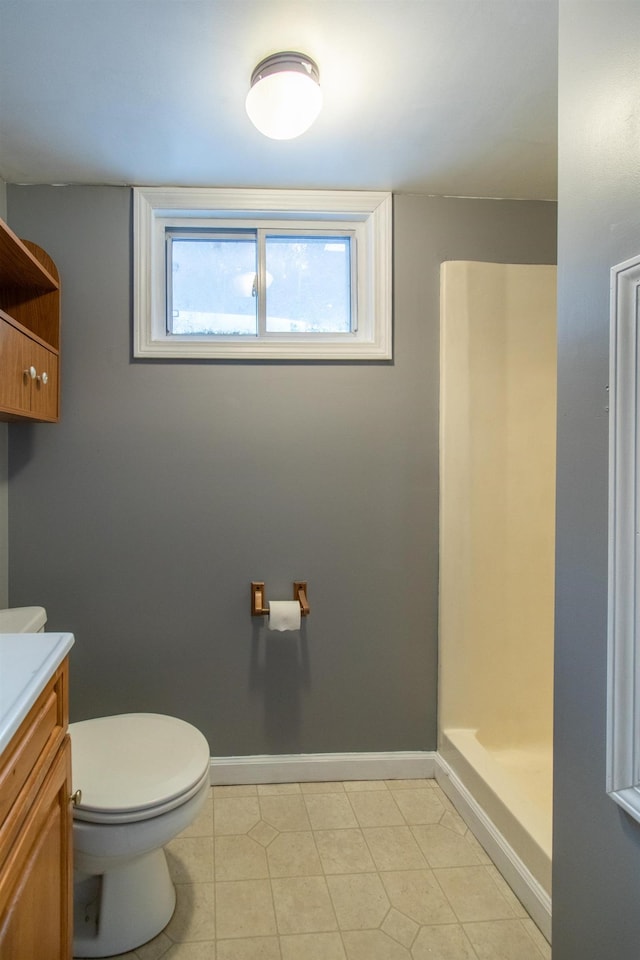 bathroom with walk in shower, vanity, and toilet