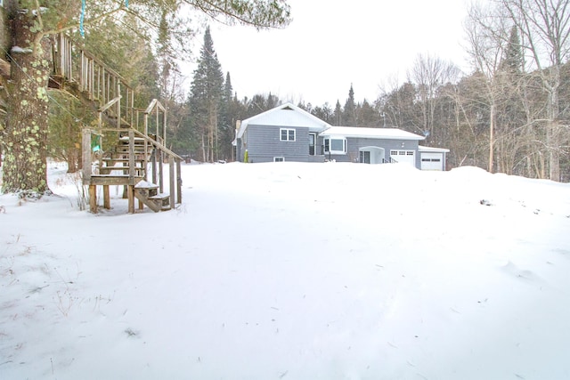 snowy yard with a garage