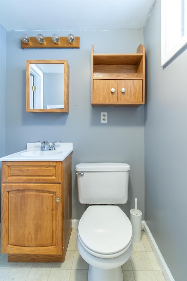 bathroom featuring tile patterned flooring, vanity, and toilet