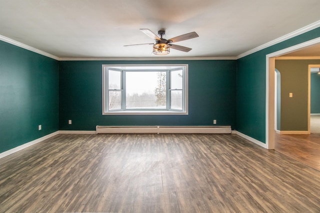 spare room featuring ceiling fan, dark hardwood / wood-style flooring, ornamental molding, and baseboard heating