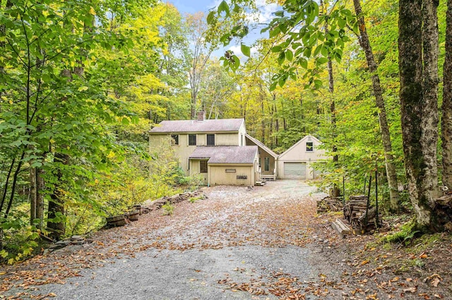 view of property featuring a garage and an outdoor structure