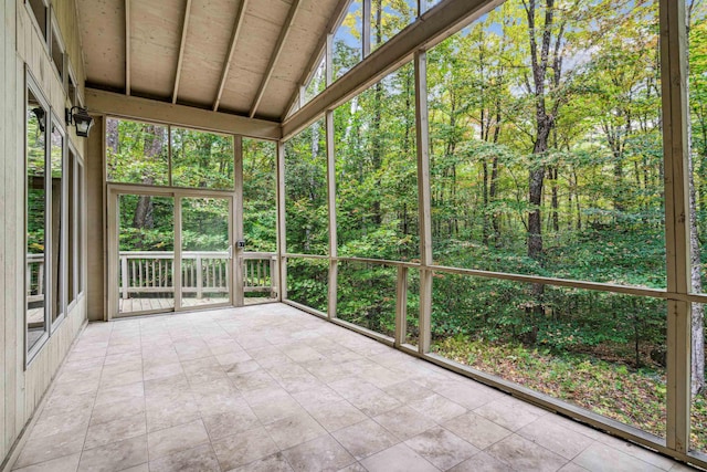 unfurnished sunroom with lofted ceiling