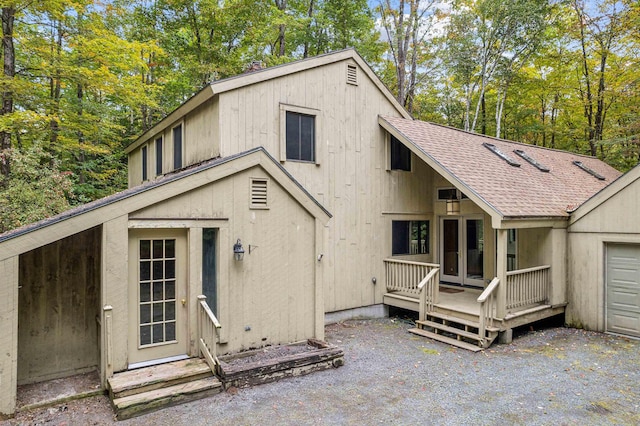 back of house with a wooden deck and french doors