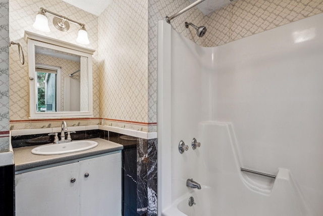 bathroom featuring bathtub / shower combination and vanity