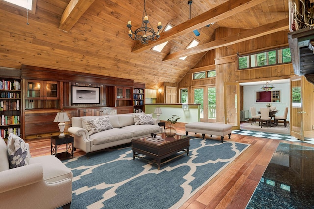 living room with wooden walls, wood-type flooring, beamed ceiling, and high vaulted ceiling