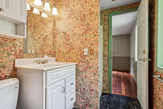 bathroom with tile patterned flooring, vanity, and toilet