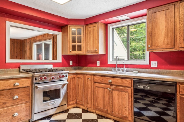 kitchen with a textured ceiling, beverage cooler, premium range, and sink