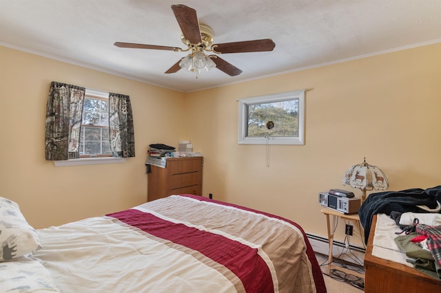 bedroom featuring ceiling fan, crown molding, a baseboard radiator, and multiple windows