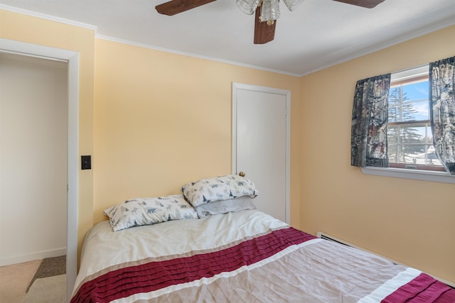 bedroom featuring ceiling fan, baseboards, ornamental molding, and carpet flooring