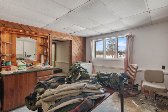 bedroom with a paneled ceiling and wooden walls