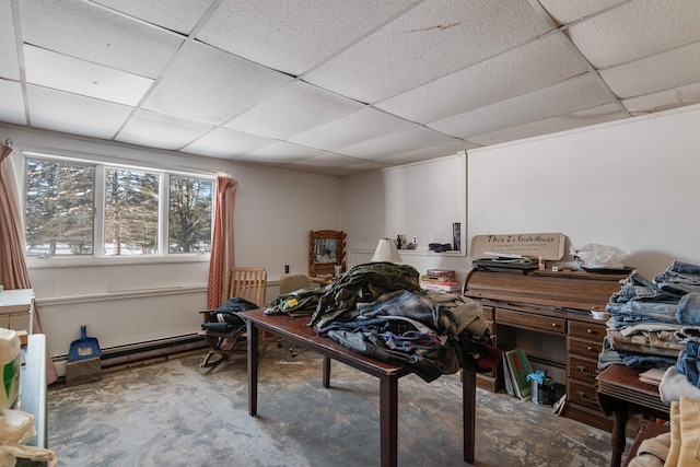 office featuring a drop ceiling, unfinished concrete flooring, and baseboard heating