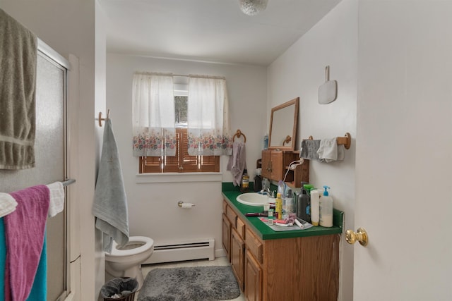 bathroom featuring toilet, a stall shower, vanity, and a baseboard radiator