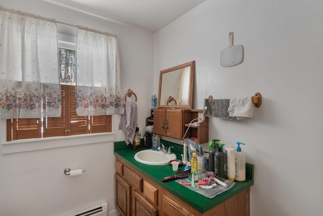 bathroom with baseboard heating and vanity