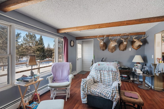 living area featuring a baseboard heating unit, a textured ceiling, plenty of natural light, beam ceiling, and dark hardwood / wood-style flooring