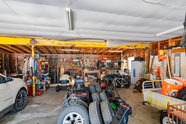 garage featuring white refrigerator and a workshop area