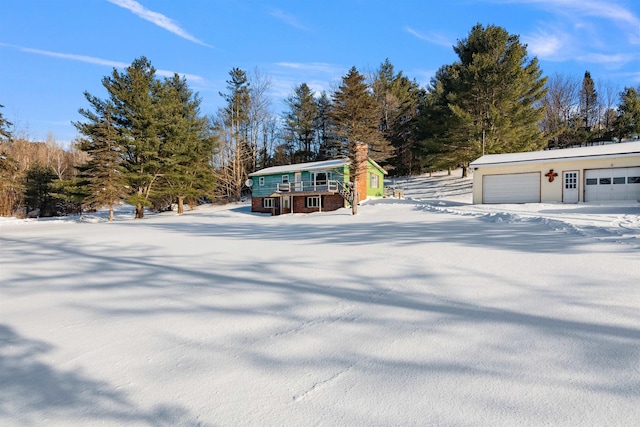 view of front of home featuring an outbuilding, a deck, and a garage