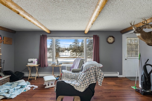 sitting room with beamed ceiling, a textured ceiling, wood finished floors, and a baseboard radiator