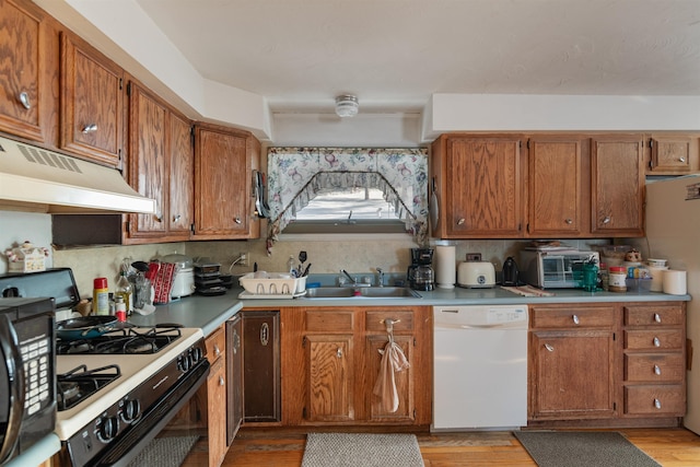 kitchen featuring sink, light hardwood / wood-style flooring, white appliances, decorative backsplash, and custom exhaust hood