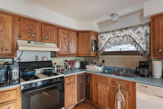 kitchen featuring white appliances, backsplash, and sink