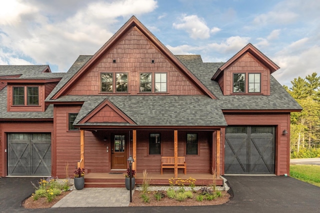 view of front of property featuring a porch and a garage