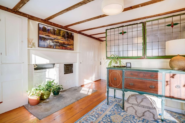 interior space with beam ceiling and wood-type flooring