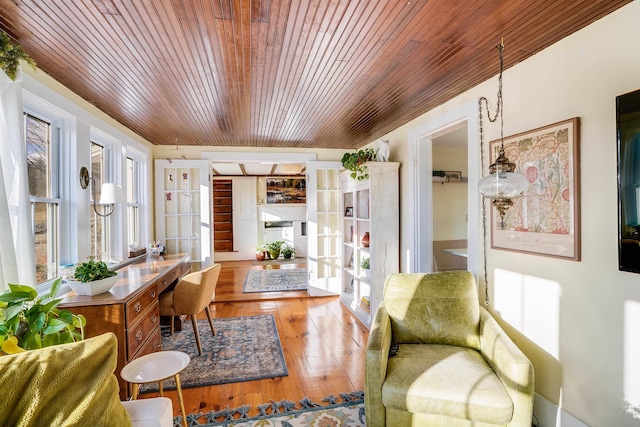 living area featuring french doors and wood-type flooring