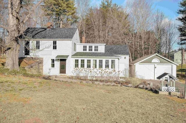 back of house featuring a yard and a storage shed