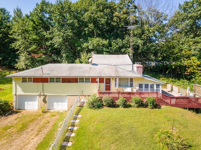 view of front of property featuring a garage and a front lawn