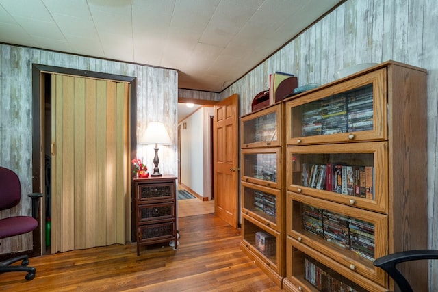 interior space featuring dark hardwood / wood-style floors and wooden walls