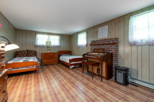 bedroom with baseboard heating and wood walls