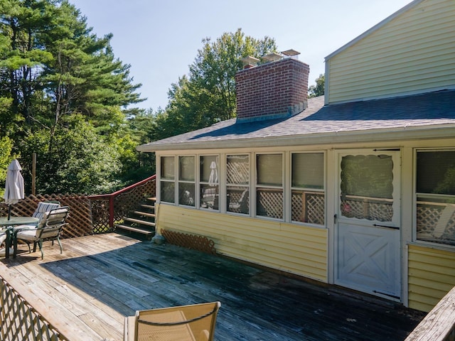 wooden deck with a sunroom