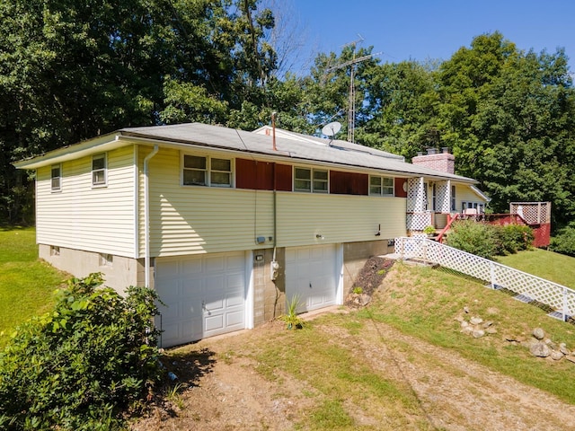 rear view of house featuring a garage