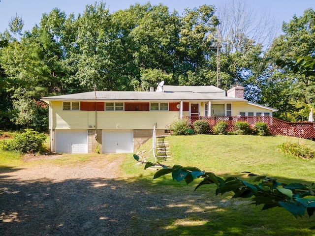 view of front facade with a front yard, a porch, and a garage