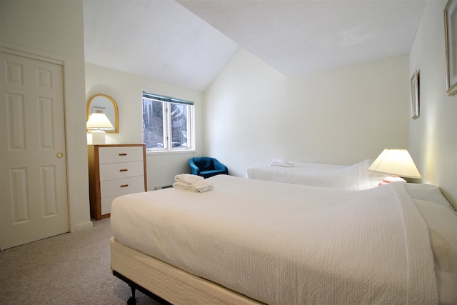 bedroom with light carpet and vaulted ceiling